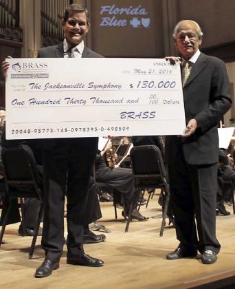 Michael Imbriani, president of BRASS, presents the check to Robert Massey, president and CEO of the Jacksonville Symphony Association. (photo submitted) 