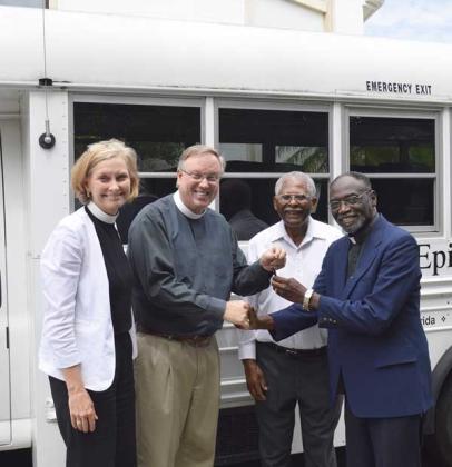 The Rev. Rick Westbury Jr., rector of Christ Episcopal Church in Ponte Vedra, presents church bus keys to the Rev. Hugh Chapman, rector of St. Philip’s Episcopal Church in downtown Jacksonville. Looking on are Rev. Amy Slater of Christ Church, left, and Sedly Huey of St. Philips,center right. (photo submitted)
